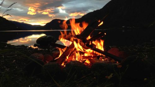 Picture of campfire overlooking a lake
